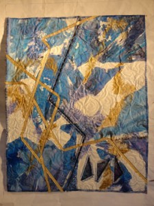Paper quilt in blue and white with gold ribbon