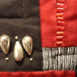 close up of silver and red beads