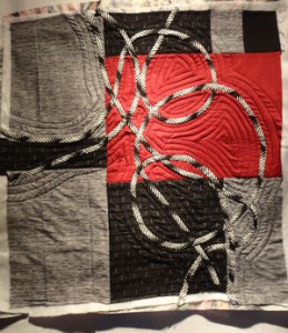  Black White and burgandy fabric with black and white bias strips looping across the sruface