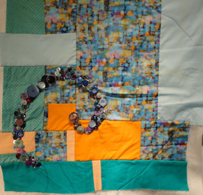 Full shot of this orange and blue quilt showing 1/3 of the spiral