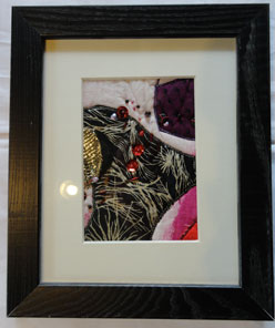 Matted and framed fiber work with black and fusha and beads of black with sequins