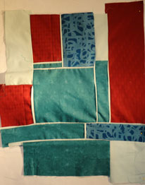 crimson, blue green, aqua and blue  quilt top