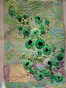 pale background with  spring green yo-yos on top and beads