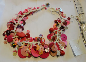 pink buttons on chained cream thread