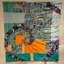 image of the quilt showing the buttons in place and the quilting