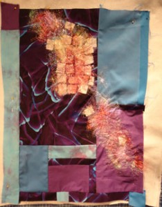 Blue and purple quilt with angelina in reds on top