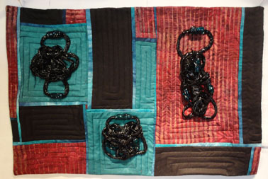 Finished quilt in Crimson, blue green, turquoise and Blaclk