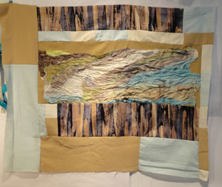 Top  in blues and browns featureing a silk landscape type center.