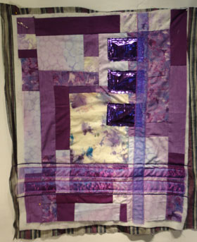 Purple quilt with ribbon and celophan added on top