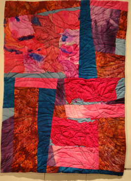 full shot of the majenta and blue quilt