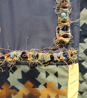 shot of the beads and the fabric scraps strung together